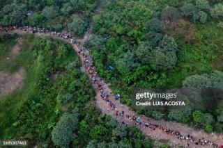 aerialviewshowingmigrantswalkingthroughthejunglenearbajochiquitovillagethefirst.jpg