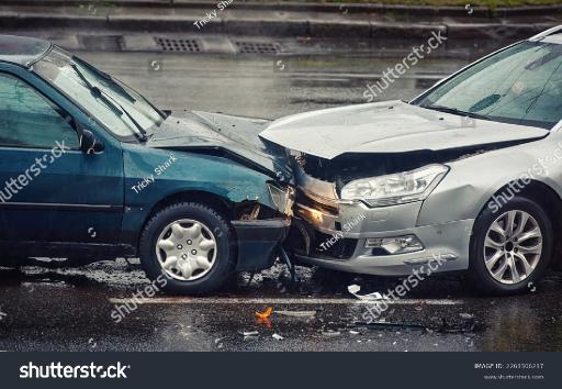 stockphotocaraccidentonwetroadduringrainheadoncollisionsideviewtwocarsdamagedafterheadon2261506217.jpg
