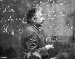 germanbornphysicistalberteinsteinstandingbesideablackboardwithchalkmarked.jpg